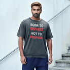 Oversized gray t-shirt with the text 'BORN TO EXPRESS NOT TO IMPRESS' printed in red on the front.