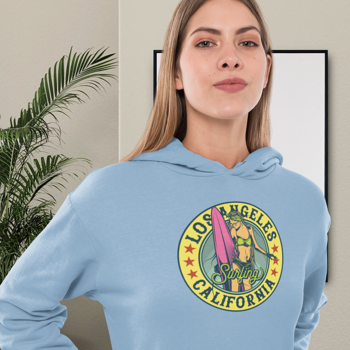 blue hoodie with a graphic print of 'Los Angeles Surfing California'.